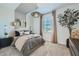 Stylish bedroom featuring a plush bed, unique light fixture, and neutral color palette at 8035 E Paloma Ave, Mesa, AZ 85212