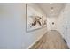 Clean hallway with elegant artwork, sleek tile flooring, and modern lighting at 8035 E Paloma Ave, Mesa, AZ 85212