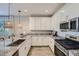 Well-equipped kitchen featuring white cabinets, granite countertops, and stainless steel appliances at 8035 E Paloma Ave, Mesa, AZ 85212