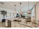 Bright, modern kitchen features granite countertops, a stainless steel sink, and wicker pendant lighting at 8035 E Paloma Ave, Mesa, AZ 85212