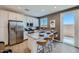 Modern kitchen with granite countertops, stainless steel appliances, and a breakfast bar for seating at 8035 E Paloma Ave, Mesa, AZ 85212