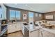 Modern kitchen showcasing granite countertops, stainless steel appliances, and a view into the living room at 8035 E Paloma Ave, Mesa, AZ 85212