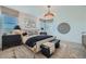 Bright main bedroom featuring a decorative wall, accent furniture, and an elegant light fixture at 8035 E Paloma Ave, Mesa, AZ 85212