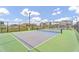 This outdoor pickleball court is enclosed with a fence in a new housing community, providing residents with a fun recreational amenity at 8035 E Paloma Ave, Mesa, AZ 85212