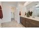 Bright bathroom with dual sink vanity, spacious shower, and access to walk-in closet at 8142 E Petra Ave, Mesa, AZ 85212