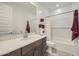 Well-lit bathroom features a single sink vanity and a bathtub-shower combination at 8142 E Petra Ave, Mesa, AZ 85212