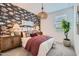Comfortable bedroom with decorative fish wallpaper and hanging light fixture at 8142 E Petra Ave, Mesa, AZ 85212