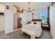 Cozy bedroom with stylish accent wall, chic lighting, and neutral carpeting at 8142 E Petra Ave, Mesa, AZ 85212