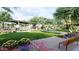 Picturesque community park with lush green lawn, seating, and colorful flower beds, offering a serene escape at 8142 E Petra Ave, Mesa, AZ 85212