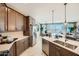 Bright kitchen features stainless steel appliances, island seating, and opens to the dining area at 8142 E Petra Ave, Mesa, AZ 85212