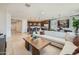 Open-concept living area with seamless flow from kitchen to dining and a large sectional sofa at 8142 E Petra Ave, Mesa, AZ 85212