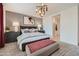 Beautiful main bedroom with stylish lighting, patterned accent wall, and neutral colors at 8142 E Petra Ave, Mesa, AZ 85212
