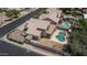 A nice aerial view of the back of the home, highlighting the deck and pool at 8469 W Emile Zola Ave, Peoria, AZ 85381