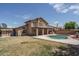The expansive backyard includes a pool, covered patio, and green space at 8469 W Emile Zola Ave, Peoria, AZ 85381
