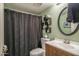 Bathroom with a shower, sink, toilet, and hardwood cabinet at 8469 W Emile Zola Ave, Peoria, AZ 85381