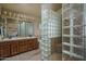 Bathroom with double sinks, glass block shower, and tile floors at 8469 W Emile Zola Ave, Peoria, AZ 85381