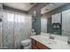 Cozy bathroom with a shower, sink, toilet and a large mirror at 8469 W Emile Zola Ave, Peoria, AZ 85381