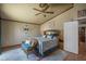 Cozy bedroom with hardwood floors, a ceiling fan, and stylish decor at 8469 W Emile Zola Ave, Peoria, AZ 85381