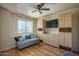 Bedroom with built-in cabinets, a couch, hardwood floors, and a ceiling fan at 8469 W Emile Zola Ave, Peoria, AZ 85381