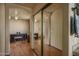 Bedroom with laminate floors, ceiling fan, and closet with mirrored sliding doors at 8469 W Emile Zola Ave, Peoria, AZ 85381