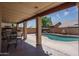 Covered patio with ample seating area for outdoor entertaining and a view of the pool at 8469 W Emile Zola Ave, Peoria, AZ 85381