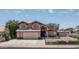 Charming two-story home featuring a well-maintained front yard, attached garage, and inviting facade at 8469 W Emile Zola Ave, Peoria, AZ 85381