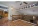 Open hallway with hardwood floors and a wooden railing to second story at 8469 W Emile Zola Ave, Peoria, AZ 85381