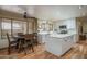 Bright kitchen featuring an island, white cabinets, modern appliances, and an adjacent dining area at 8469 W Emile Zola Ave, Peoria, AZ 85381