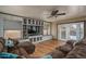Comfortable living room with built-in shelving, hardwood floors, natural light, and a cozy seating area at 8469 W Emile Zola Ave, Peoria, AZ 85381