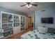 Office with hardwood floors, built in shelves, and a TV at 8469 W Emile Zola Ave, Peoria, AZ 85381