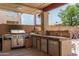 An outdoor kitchen with a grill and sink is perfect for outdoor gatherings at 8469 W Emile Zola Ave, Peoria, AZ 85381