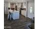 Kitchen with white cabinets, marble countertops, a center island with seating, and stainless appliances at 909 W Mesquite St, Chandler, AZ 85225