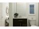Stylish bathroom featuring a dark vanity with white countertop and oval mirror at 919 W Peralta Pass, Apache Junction, AZ 85120