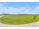 Expansive community park featuring lush green lawns, walking paths and beautiful mountain views in the background at 919 W Peralta Pass, Apache Junction, AZ 85120