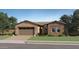 Charming single story home featuring a 2-car garage, desert landscaping, and neutral stucco and stone exterior at 919 W Peralta Pass, Apache Junction, AZ 85120