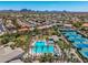 Aerial view showcasing community amenities: pool, tennis courts, and lush, mature landscaping at 9571 N 117Th St, Scottsdale, AZ 85259