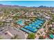 High angle of tennis courts and community pool nestled in an upscale neighborhood with mountain views at 9571 N 117Th St, Scottsdale, AZ 85259