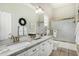 Bright bathroom featuring double sinks, granite countertops, and a shower-tub combo at 9571 N 117Th St, Scottsdale, AZ 85259