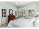 Light and airy bedroom featuring bright blue paint, shutters, and plush carpeting at 9571 N 117Th St, Scottsdale, AZ 85259