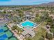 Aerial view of a community pool with lap lanes and a separate recreation pool surrounded by palm trees at 9571 N 117Th St, Scottsdale, AZ 85259