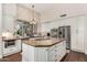 Well-appointed kitchen featuring a large island, stone backsplash, and modern appliances at 9571 N 117Th St, Scottsdale, AZ 85259