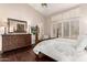 Comfortable main bedroom featuring elegant furnishings, ample natural light, and hardwood floors at 9571 N 117Th St, Scottsdale, AZ 85259