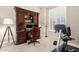This office features a stunning hutch desk and exercise equipment for work and wellness at 9571 N 117Th St, Scottsdale, AZ 85259