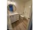 Updated bathroom featuring modern vanity, mirror, toilet, and shower and tub with wood look floors at 97 N Cooper Rd # 97, Chandler, AZ 85225
