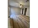 Spacious bedroom with modern ceiling fan, vinyl plank flooring, sliding door and en-suite closet at 97 N Cooper Rd # 97, Chandler, AZ 85225