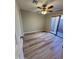The bright bedroom features stylish wood-look floors, neutral walls, ceiling fan and door to patio at 97 N Cooper Rd # 97, Chandler, AZ 85225