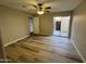 Bedroom with wood-look floors, ceiling fan, and sliding glass door to patio at 97 N Cooper Rd # 97, Chandler, AZ 85225