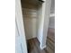 White closet featuring rod, shelving and wood-look floors in a freshly painted room at 97 N Cooper Rd # 97, Chandler, AZ 85225