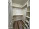 A walk-in closet offering customized storage solutions including shelving and a hanging rod at 97 N Cooper Rd # 97, Chandler, AZ 85225