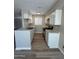 Renovated kitchen with white cabinets, stainless steel appliances, and stylish flooring at 97 N Cooper Rd # 97, Chandler, AZ 85225